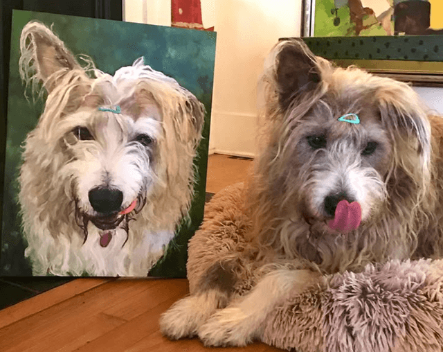 A dog next to a painting made by Roberta Durra